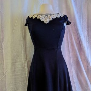 Navy blue mini dress with white lace collar.